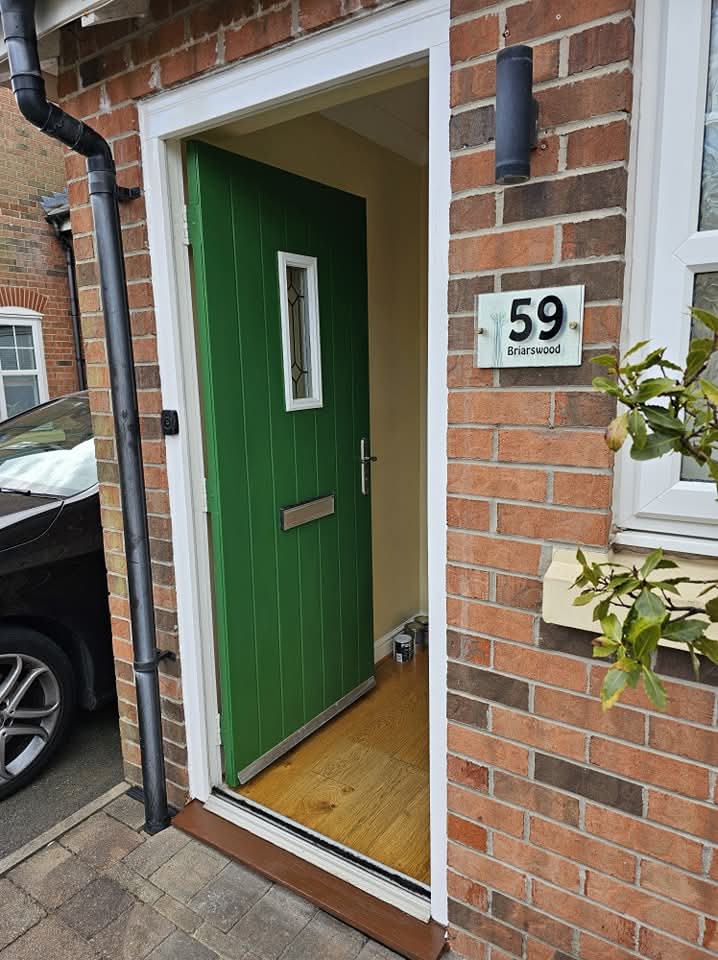Front door resprayed in a deep green satin finish by Fresh Coat Decorators