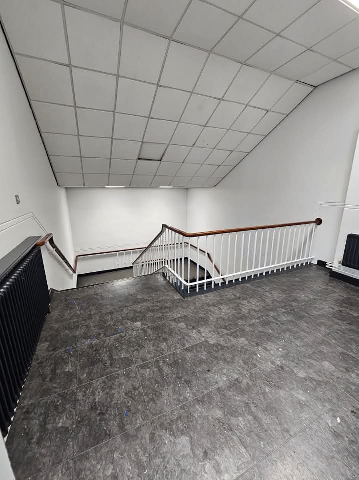 Finished Cheshire stairwell landing with smooth white walls and tidy paintwork