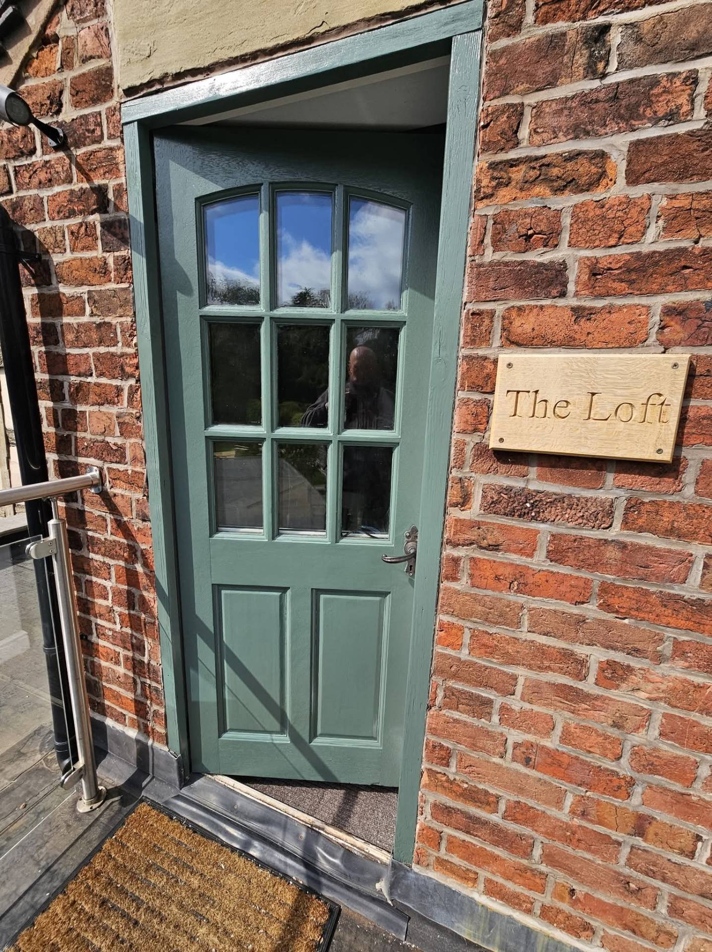 Same Cheshire timber door and frame repainted in a fresh sage green finish after exterior painting