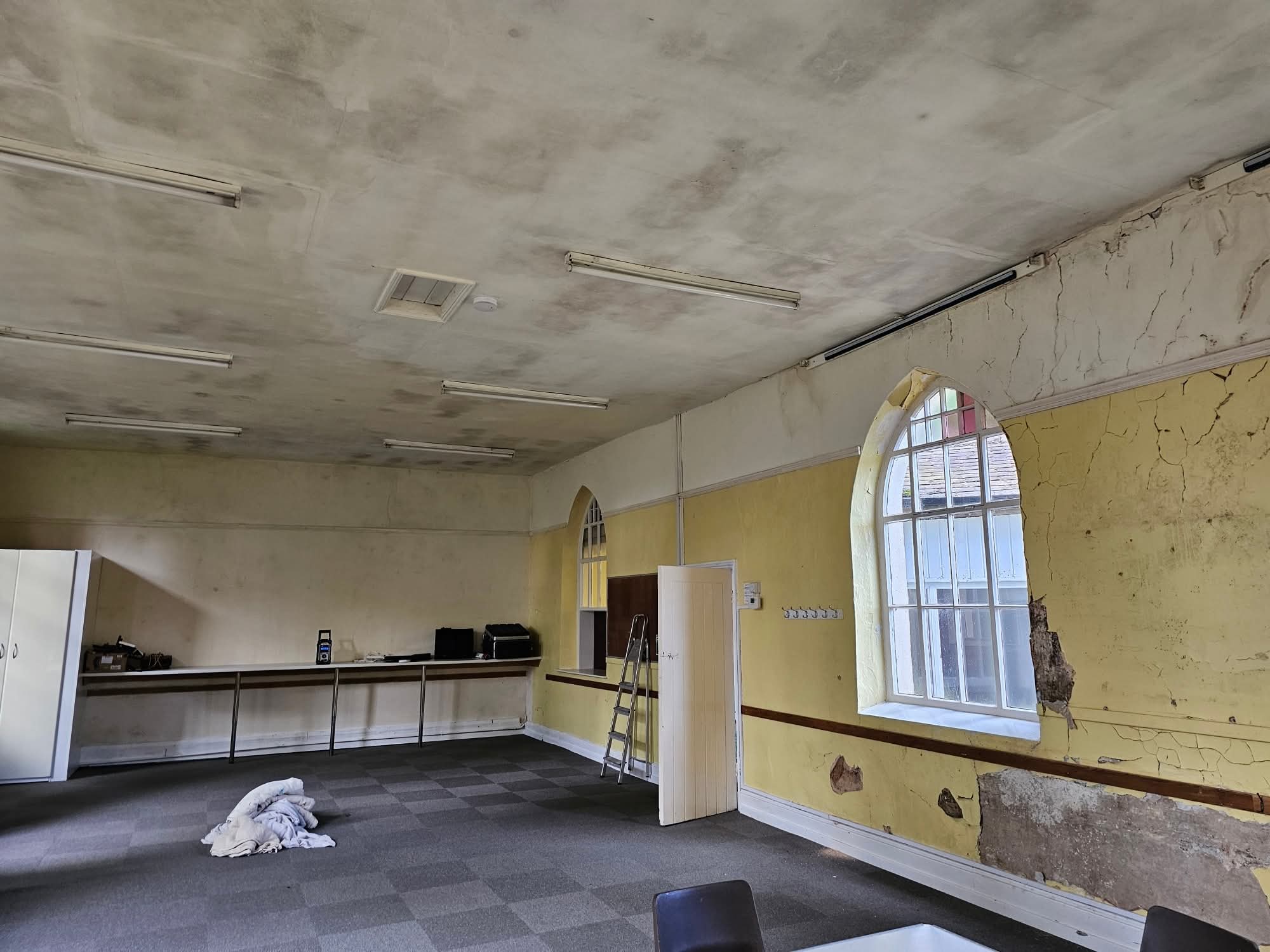 Community hall in Congleton with tired yellow walls before decorating